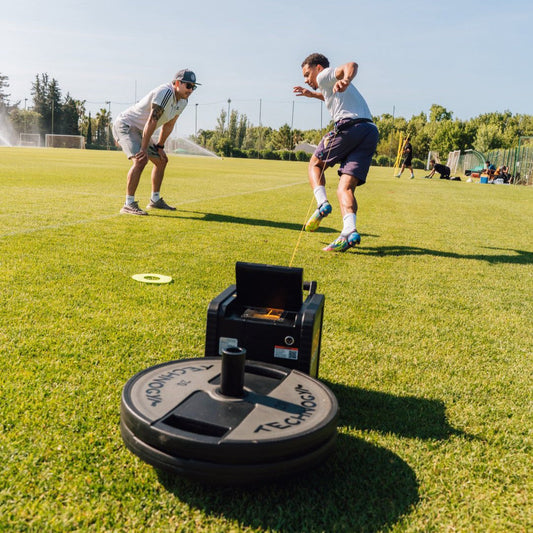 Athlete sprinting with the 1080 Sprint during acceleration training for team sports like soccer and basketball.
