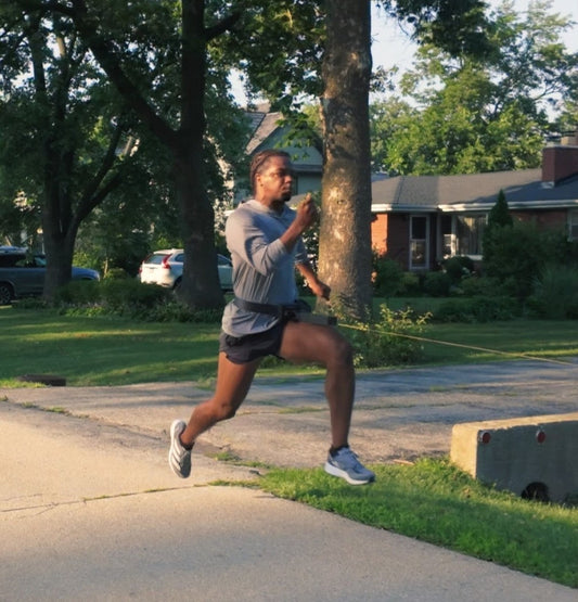 Athlete doing overspeed sprinting with 1080 Sprint 2 and assisted sprint drills